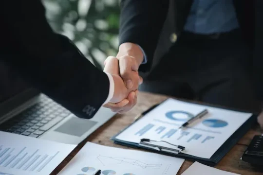 business-investor-group-holding-hands-two-businessmen-are-agreeing-business-together-shaking-hands-after-successful-negotiation-handshaking-is-western-greeting-congratulation_